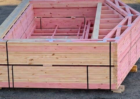 Packed stack of pre-made timber truss components ready for dispatch