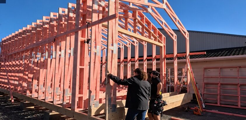 Completed run of timber portal trusses forming floor, walls and roof